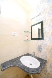 a bathroom with a sink and a mirror at AeroStay Comfort Inn - Near Ranchi Airport in Rānchī +43 photos