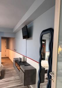 a living room with a table and a fireplace at Le camere del Cappello Verde in Ivrea