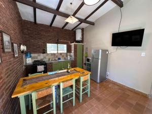 a kitchen with a wooden counter and a refrigerator at La Maguada in Tanti