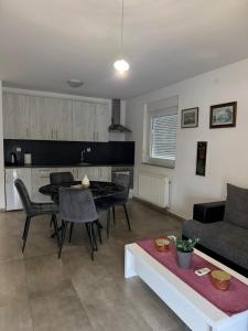 a living room with a table and a couch at Apartman Lapaž 14 in Toplice Sveti Martin