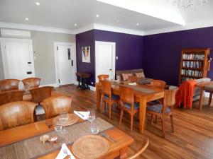 a dining room with a table and chairs at Lupton Lodge in Whangarei