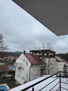 a view of a building with snow on the roof at Apartman Lapaž 14 in Toplice Sveti Martin