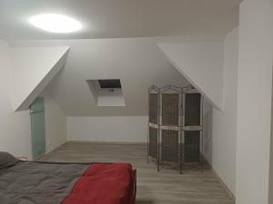 a attic room with a bed and a cage at Dolina dwóch stawów in Piorkowo +4 photos