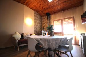 a dining room with a table with wine glasses on it at VISTA BELLA am Gardasee in San Zeno di Montagna