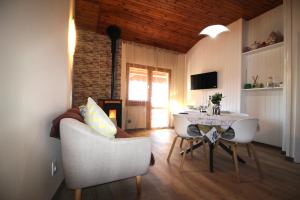 a living room with a couch and a table and chairs at VISTA BELLA am Gardasee in San Zeno di Montagna