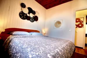 a bedroom with a bed with pans on the wall at VISTA BELLA am Gardasee in San Zeno di Montagna