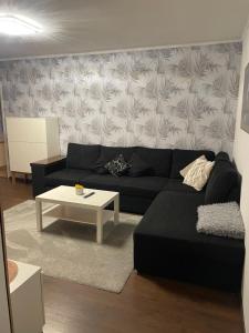 a living room with a black couch and a coffee table at Laane in Võru +1 photo