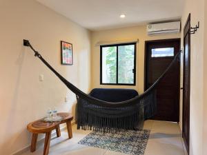 a room with a hammock in the corner of a room at Esencia Valladolid Hotel in Valladolid