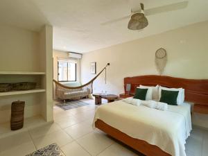 a bedroom with a bed and a hammock in it at Esencia Valladolid Hotel in Valladolid +29 photos