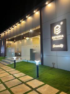 a building with a sign on the side of it at Estoria Hotel and Resort in Mysore +10 photos
