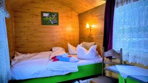 a bedroom with a bed in a wooden room at Poiana Stelelor in Văleni