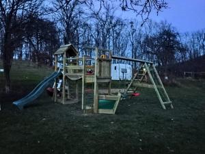 a playground with a slide and a swing set at Poiana Stelelor in Văleni