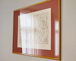 a framed picture of a curtain hanging on a wall at UNEA Aparthotel in Leipzig - Vollausgestattete Apartments in Leipzig