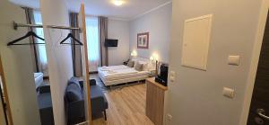 a small living room with a couch and a mirror at UNEA Aparthotel in Leipzig - Vollausgestattete Apartments in Leipzig