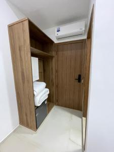 a room with a wooden cabinet with towels in it at Hôtel kairouan in Fez