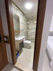 a bathroom with a toilet and a sink at Hôtel kairouan in Fez