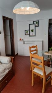 a dining room with a table and a chair at Cerca de Todo in Miramar