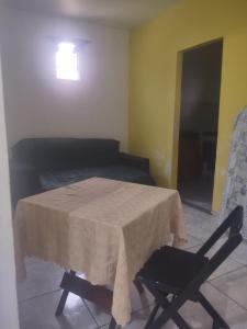a room with a table and a chair and a bed at Espaço em Pero hospedagem in Cabo Frio +11 photos