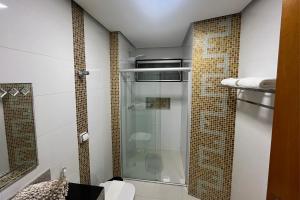 a bathroom with a shower with a glass door at Mega Palace Hotel in Morrinhos +23 photos