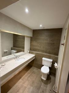 a bathroom with a white toilet and a sink at West Cork Hotel in Skibbereen