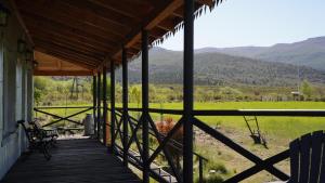 a porch of a house with mountains in the background at La Loica in El Maitén