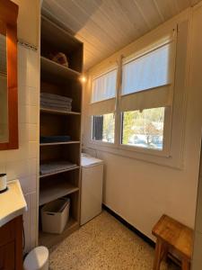 a bathroom with a toilet and a window in it at L'appart de Serre Che in La Salle Les Alpes