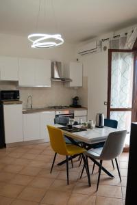 a kitchen with a table and chairs in a room at Urban Chic Apartment in Valmontone