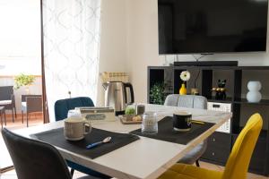 a dining room table with two coffee mugs on it at Urban Chic Apartment in Valmontone