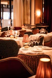 a row of tables with wine glasses on them at Hôtel Aventure in Paris