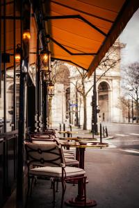 a row of tables and chairs on a street at Hôtel Aventure in Paris