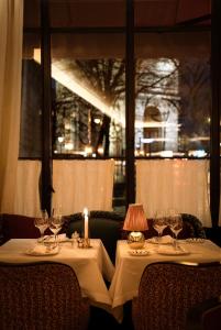 a table with wine glasses and a candle on it at Hôtel Aventure in Paris +33 photos