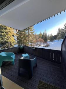 a deck with a view of the snow covered trees at L'appart de Serre Che in La Salle Les Alpes