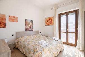 een slaapkamer met een bed met handdoeken erop bij Dimoras Bellissimo Appartamento Centrocittà in Olbia