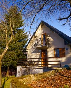 a white house with a balcony and a tree at Home rent NABRDO in Kolašin +56 photos