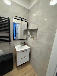 a bathroom with a sink and a mirror at MW 4A Apartament in Rzeszów