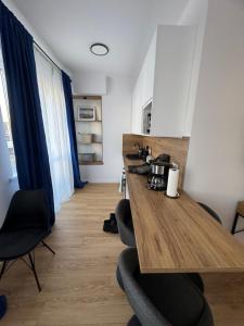a room with a wooden table and chairs at MW 4A Apartament in Rzeszów