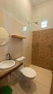 a bathroom with a toilet and a sink and a shower at Beach Chalet Preá in Prea +59 photos