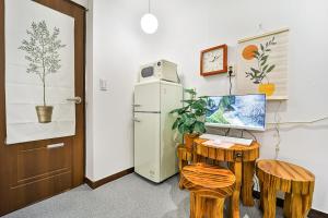 a room with a refrigerator and a desk with a computer at Bokman stay 01 in Seoul