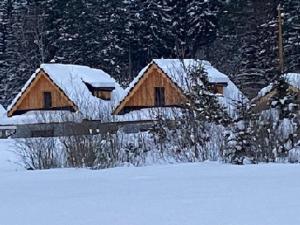 a couple of houses covered in snow at Chata Spomienka in Lúčky