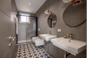 a bathroom with a sink and a toilet and a mirror at Rotolo Roof 21 5C in Catania +41 photos