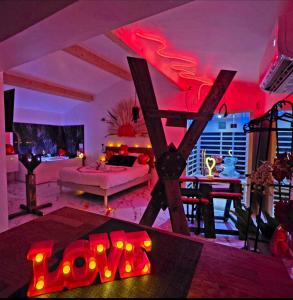 a living room with red lighting and a room with a couch at Maisons Plaisir & Pulsion Spa Sauna Privé in Allauch