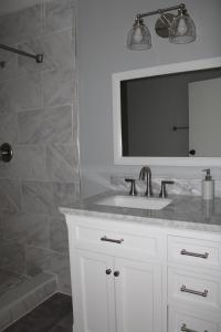 a bathroom with a sink and a mirror and a shower at Cottage & Garden in Jacksonville +23 photos