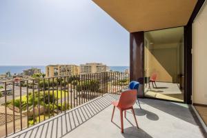 a balcony with chairs and a view of the ocean at Rotolo Roof 21 5C in Catania