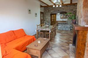 a living room with a couch and a table at Casa rural BUSEO in Chera