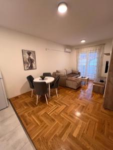 a living room with a table and a couch at Apartman Luka in Cetinje
