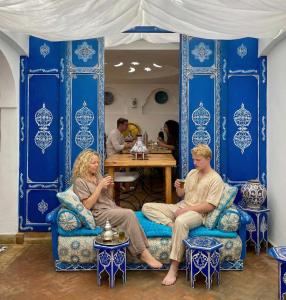 a man and woman sitting in chairs in a room at Hotel Al Alba Hammam & Restaurant in Asilah +43 photos
