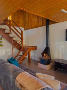 a living room with a couch and a fireplace at Quinta Sol Montês in Rancho Queimado