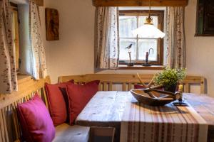 a dining room table with a bowl of flowers and a window at Chalet Mühlburger in Gruben +40 photos