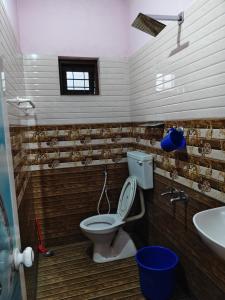 a bathroom with a toilet and a sink at Quality Inn Resort in Varkala