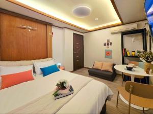 a hotel room with a large bed and a table at MIIN Stay02 in Seoul